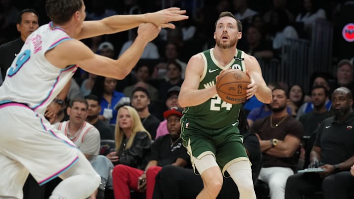 Apr 5, 2025; Miami, Florida, USA;  Milwaukee Bucks guard Pat Connaughton (24) takes a shot as Miami Heat guard Pelle Larsson (9) defends during the second half at Kaseya Center. Mandatory Credit: Jim Rassol-Imagn Images