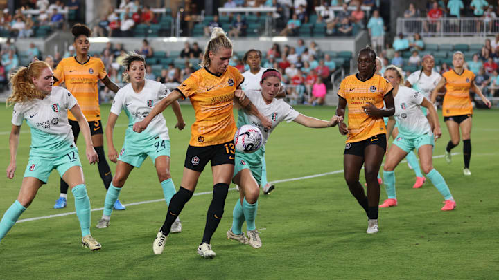 Jun 28, 2024; Kansas City, Missouri, USA; Houston Dash midfielder Sophie Schmidt (13) battles Kansas City Current defender Isabel Rodriguez (18) for the ball in the second half at CPKC Stadium. Mandatory Credit: William Purnell-USA TODAY Sports