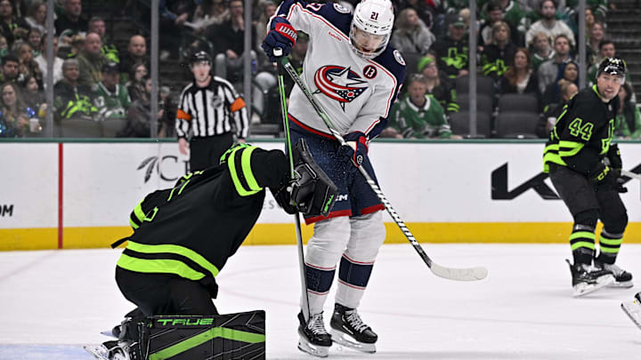 Feb 2, 2025; Dallas, Texas, USA; Columbus Blue Jackets left wing James van Riemsdyk (21) leaps in front of Dallas Stars goaltender Casey DeSmith (1) during the third period at the American Airlines Center. Mandatory Credit: Jerome Miron-Imagn Images