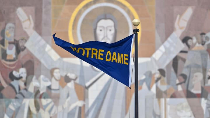 Nov 19, 2022; South Bend, Indiana, USA; A Notre Dame pennant flies in front of the Word of Life Mural, commonly known as Touchdown Jesus, before the game between the Notre Dame Fighting Irish and the Boston College Eagles at Notre Dame Stadium. Nov 19, 2022; South Bend, Indiana, USA; A Notre Dame pennant flies in front of the Word of Life Mural, commonly known as Touchdown Jesus, before the game between the Notre Dame Fighting Irish and the Boston College Eagles at Notre Dame Stadium.