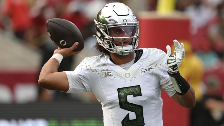 Sep 26, 2026; Los Angeles, California, USA;  Oregon Ducks quarterback Dante Moore (5) throws a pass against the USC Trojans during the first half at United Airlines Field at Los Angeles Memorial Coliseum.  Mandatory Credit: Kiyoshi Mio-Imagn Images