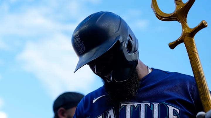 Seattle Mariners right fielder Teoscar Hernandez (35) grabs the celebratory trident after hitting a