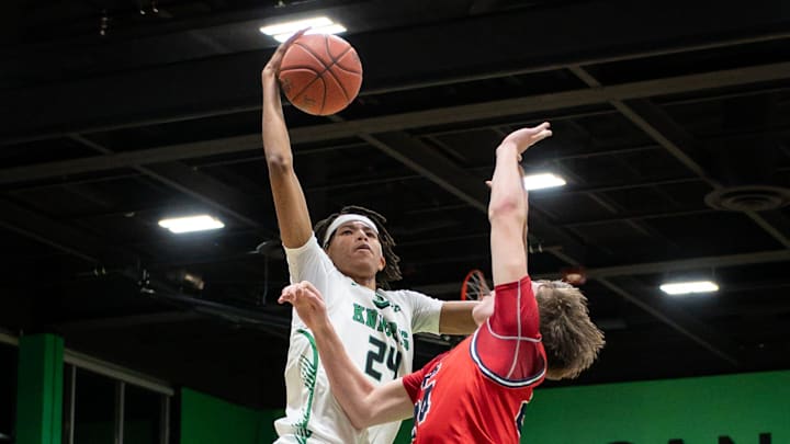 Dominican forward Aaron Womack III goes to the basket against Prairie School forward Dalton Ahlensdorf in a game Tuesday, February 4, 2025, at Dominican High School in Whitefish Bay, Wisconsin.