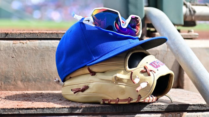 Feb 27, 2024; Mesa, Arizona, USA;  General view of a Chicago Cubs glove, hat and glasses in the first inning against the Cincinnati Reds during a spring training game at Sloan Park