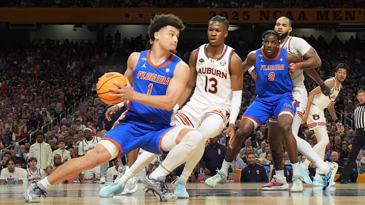 Florida Gators guard Walter Clayton Jr. (1) is defended by Auburn Tigers guard Miles Kelly (13) in the semifinals of the men's Final Four of the 2025 NCAA Tournament at the Alamodome. 
