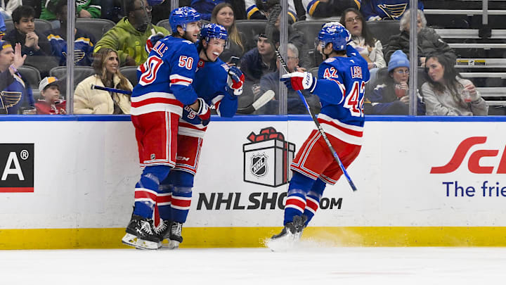 Dec 18, 2025; St. Louis, Missouri, USA; New York Rangers right wing Gabe Perreault (94) celebrates with left wing Will Cuylle (50) and center Noah Laba (42) after scoring his first NHL goal during the second period against the St. Louis Blues at Enterprise Center. Mandatory Credit: Jeff Curry-Imagn Images