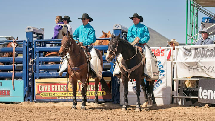 Former saddle bronc world champion Taos Muncy, right, is now serving as a pickup man, learning from veterans like Matt Twitchell, left. Both men have been nominated for PRCA Pickup Man of the Year. 
