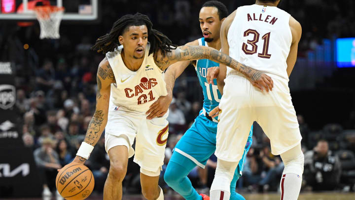 Apr 14, 2024; Cleveland, Ohio, USA; Cleveland Cavaliers forward Emoni Bates (21) dribbles around Charlotte Hornets guard Amari Bailey (10) in the second 
quarter at Rocket Mortgage FieldHouse. Mandatory Credit: David Richard-USA TODAY Sports