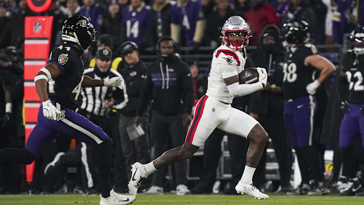 Dec 21, 2025; Baltimore, Maryland, USA;  New England Patriots wide receiver Stefon Diggs (8) runs after a catch against Baltimore Ravens cornerback Marlon Humphrey (44) during the first half of the game at M&T Bank Stadium. Mandatory Credit: James Lang-Imagn Images