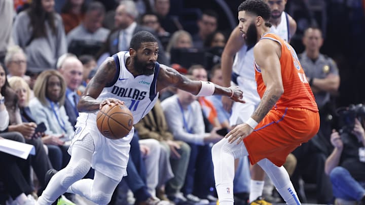 Dec 10, 2024; Oklahoma City, Oklahoma, USA; Dallas Mavericks guard Kyrie Irving (11) drives around Oklahoma City Thunder forward Kenrich Williams (34) during the second quarter at Paycom Center. Mandatory Credit: Alonzo Adams-Imagn Images
