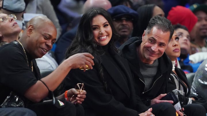 Vanessa Bryant sits between Dave Chapelle and Lakers general manager Rob Pelinka during the 2022 NBA All-Star Game at Rocket Mortgage FieldHouse. Vanessa Bryant sits between Dave Chapelle and Lakers general manager Rob Pelinka during the 2022 NBA All-Star Game at Rocket Mortgage FieldHouse.