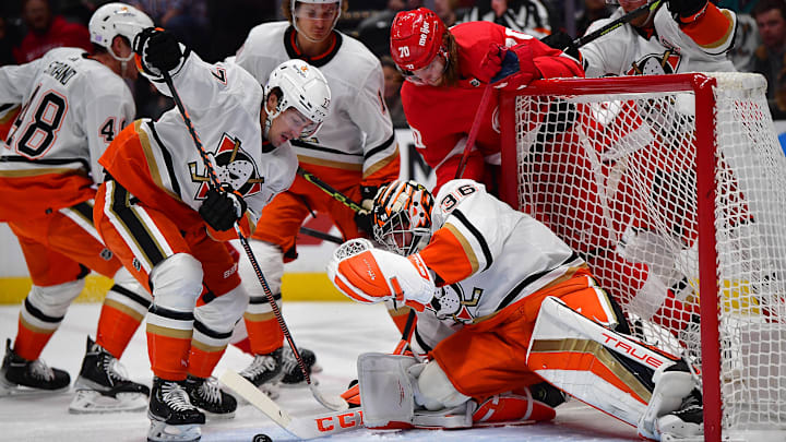 Nov 15, 2022; Anaheim, California, USA; Anaheim Ducks right wing Frank Vatrano (77) helps goaltender John Gibson (36) defend the goal against Detroit Red Wings center Oskar Sundqvist (70) during the first period at Honda Center. Mandatory Credit: Gary A. Vasquez-Imagn Images