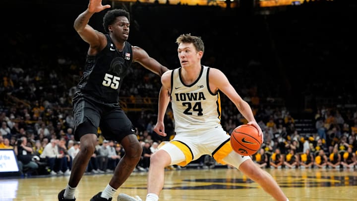 Iowa forward Pryce Sandfort (24) drives to the basket against Michigan State forward Coen Carr (55) during a Big Ten Conference game Thursday, March 6, 2025 at Carver-Hawkeye Arena in Iowa City.