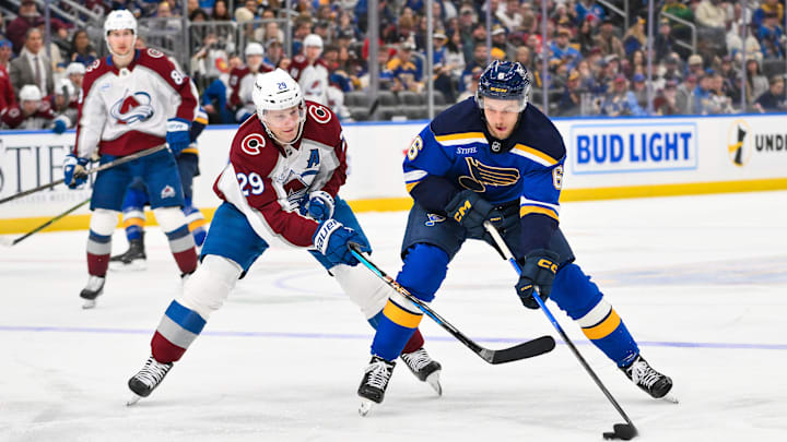 Apr 7, 2026; St. Louis, Missouri, USA; St. Louis Blues defenseman Philip Broberg (6) controls the puck as Colorado Avalanche center Nathan MacKinnon (29) defends during the second period at Enterprise Center. Mandatory Credit: Jeff Curry-Imagn Images