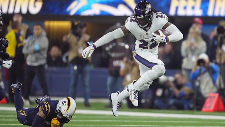 Baltimore Ravens running back Derrick Henry (22) carries the ball against cornerback Elijah Molden (22) in the second half at SoFi Stadium. Baltimore Ravens running back Derrick Henry (22) carries the ball against cornerback Elijah Molden (22) in the second half at SoFi Stadium.