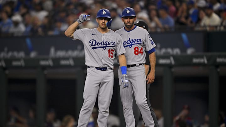 Apr 20, 2025; Arlington, Texas, USA; Los Angeles Dodgers catcher Austin Barnes (15) and first base coach/infield coach Chris Woodward (84) during the game between the Texas Rangers and the Los Angeles Dodgers at Globe Life Field. Mandatory Credit: Jerome Miron-Imagn Images