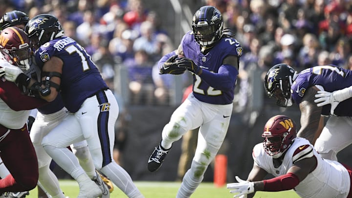 Oct 13, 2024; Baltimore, Maryland, USA; Baltimore Ravens running back Derrick Henry (22) rushes through the hole during the first half against the Washington Commanders at M&T Bank Stadium. Mandatory Credit: Tommy Gilligan-Imagn Images Oct 13, 2024; Baltimore, Maryland, USA; Baltimore Ravens running back Derrick Henry (22) rushes through the hole during the first half against the Washington Commanders at M&T Bank Stadium. Mandatory Credit: Tommy Gilligan-Imagn Images