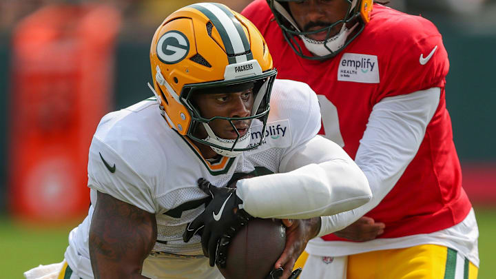 Green Bay Packers running back MarShawn Lloyd (32) takes a handoff in a drill during practice on Tuesday, August 12, 2025, at Ray Nitschke Field in Ashwaubenon, Wis. 