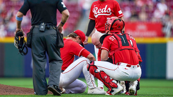 Cincinnati Reds pitcher Brady Singer (51) kneels to the ground after being hit in the foot by a line drive in the second inning of a MLB game between the Cincinnati Reds and Washington Nationals, Tuesday, May 12, 2026, at Great American Ball Park in downtown Cincinnati.