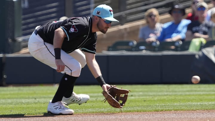Arizona Diamondbacks second baseman Garrett Hampson fields a ground ball against the Texas Rangers during Cactus League play at Salt River Fields on March 9, 2025. Arizona Diamondbacks second baseman Garrett Hampson fields a ground ball against the Texas Rangers during Cactus League play at Salt River Fields on March 9, 2025.