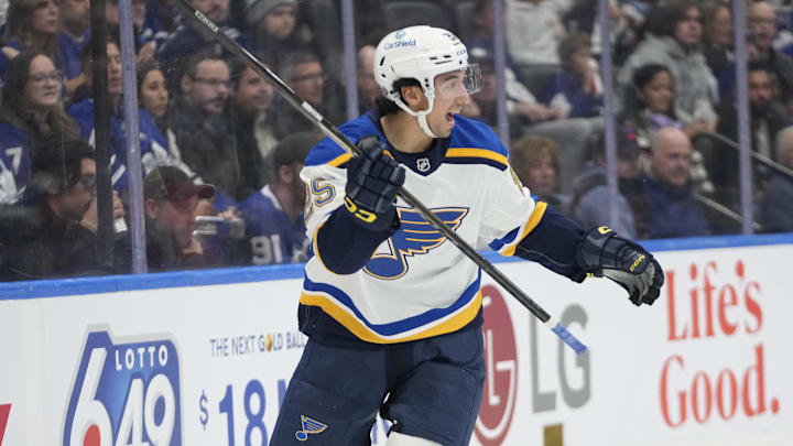 Oct 24, 2024; Toronto, Ontario, CAN; St. Louis Blues forward Jordan Kyrou (25) reacts after assisting on a goal by forward Alexandre Texier (not pictured) during the second period against the Toronto Maple Leafs at Scotiabank Arena. Mandatory Credit: John E. Sokolowski-Imagn Images