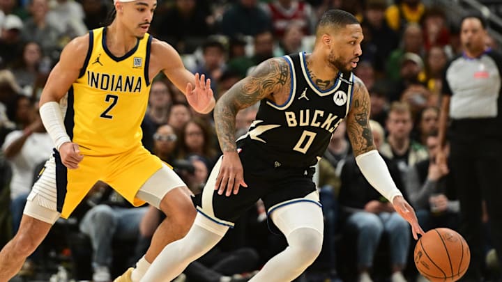 Apr 27, 2025; Milwaukee, Wisconsin, USA; Milwaukee Bucks guard Damian Lillard (0) drives for the basket against Indiana Pacers guard Andrew Nembhard (2) in the first quarter during game four of first round for the 2024 NBA Playoffs at Fiserv Forum. Lillard left the game early in the in the first quarter with an injury. Mandatory Credit: Benny Sieu-Imagn Images