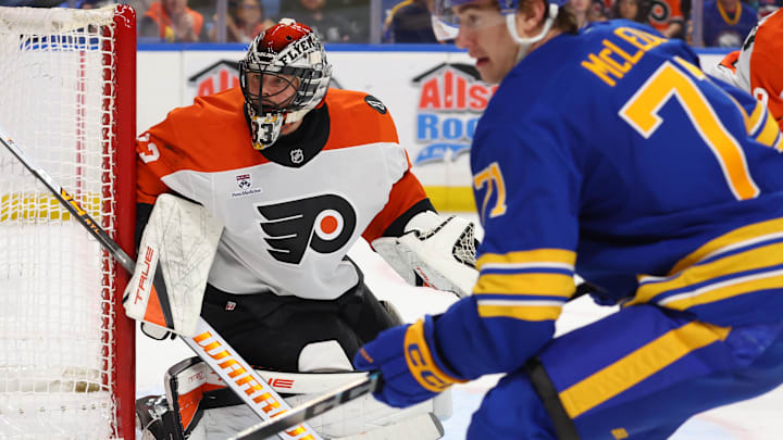 Jan 14, 2026; Buffalo, New York, USA;  Philadelphia Flyers goaltender Samuel Ersson (33) and Buffalo Sabres center Ryan McLeod (71) look for the puck during the second period at KeyBank Center. 