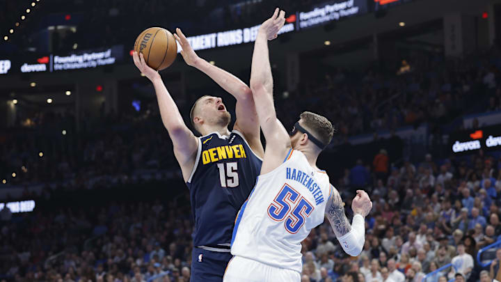 Mar 10, 2025; Oklahoma City, Oklahoma, USA; Denver Nuggets center Nikola Jokic (15) shoots as Oklahoma City Thunder center Isaiah Hartenstein (55) defends during the second quarter at Paycom Center.