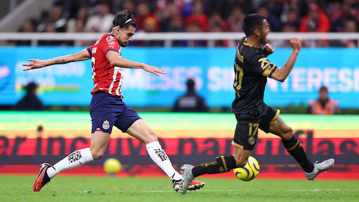 Ricardo Marín (left) lets fly with his game-winning shot as Toluca defender Brian García  tries to close down the angle. The Chivas defeated the visiting Diablos Rojos 3-2 in a Matchday 4 contest.