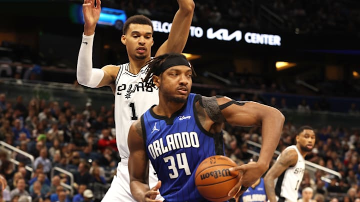 Orlando Magic center Wendell Carter Jr. (34) drives to the basket as San Antonio Spurs center Victor Wembanyama (1) defends during the second quarter at Kia Center.