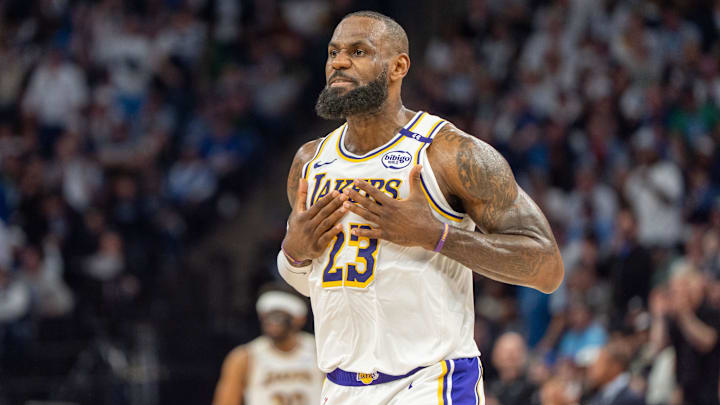 Apr 27, 2025; Minneapolis, Minnesota, USA: Los Angeles Lakers forward LeBron James (23) talks with his coach during a stoppage in play against the Minnesota Timberwolves in the second quarter during game four of first round for the 2025 NBA Playoffs at Target Center. Mandatory Credit: Matt Blewett-Imagn Images