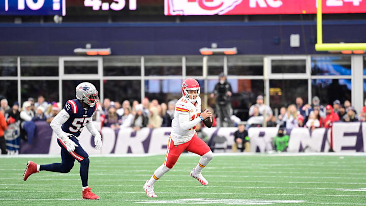 Dec 17, 2023; Foxborough, Massachusetts, USA; Kansas City Chiefs quarterback Patrick Mahomes (15) scrambles as New England Patriots linebacker Josh Uche (55) chases him during the second half at Gillette Stadium. Mandatory Credit: Eric Canha-Imagn Images
