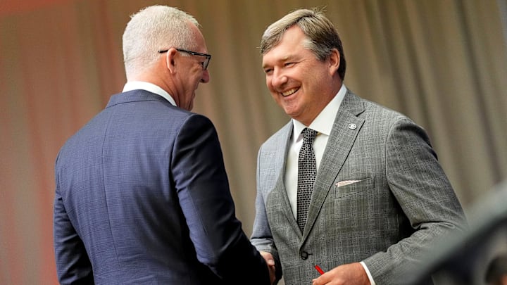 Georgia head coach Kirby Smart is welcomed to the podium in the Main Media Room by SEC Commissioner Greg Sankey during SEC Media Days at the College Football Hall of Fame in Atlanta.