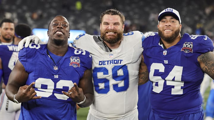 Aug 8, 2024; East Rutherford, New Jersey, USA;  New York Giants defensive tackle Rakeem Nunez-Roches (93), Detroit Lions defensive end Pat O'Connor (69) and New York Giants guard Aaron Stinnie (64) pose for a group photo after their preseason game at MetLife Stadium. Mandatory Credit: Scott Rausenberger-Imagn Images