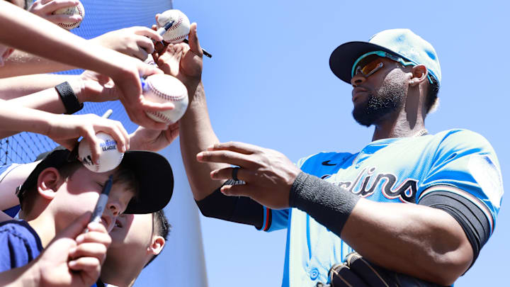 Miami Marlins second baseman Otto Lopez (6) signs autographs at spring training. 