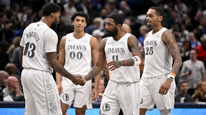 Feb 21, 2025; Dallas, Texas, USA; Dallas Mavericks guard Kyrie Irving (11) and forward Naji Marshall (13) and guard Max Christie (00) and forward P.J. Washington (25) celebrate after Irving makes a three point shot against the New Orleans Pelicans during the second half at the American Airlines Center. Mandatory Credit: Jerome Miron-Imagn Images