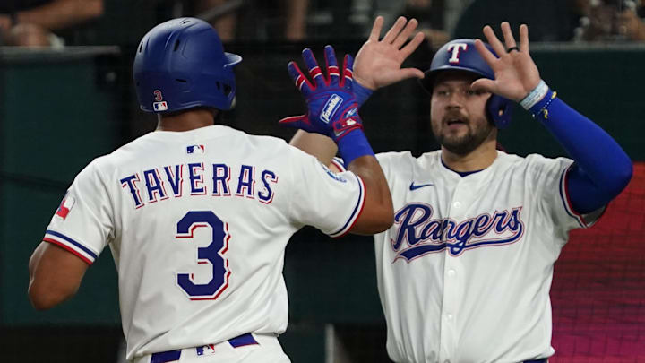 Texas Rangers center fielder Leody Taveras (3) is greeted by third baseman Jake Burger (21) after scoring during the second inning against the Los Angeles Angels at Globe Life Field on April 16.