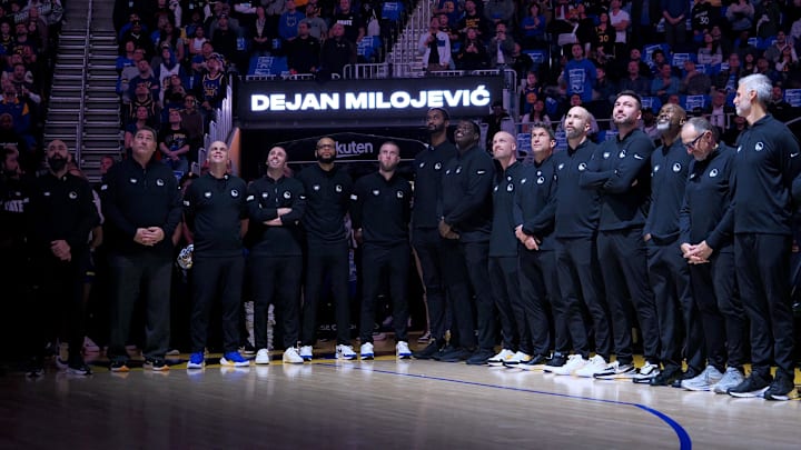 Golden State Warriors coaching staff stand in honor of the late assistant coach Dejan Milojevic before a game against the Atlanta Hawks at Chase Center. Mandatory Credit: Kelley L Cox-Imagn Images Golden State Warriors coaching staff stand in honor of the late assistant coach Dejan Milojevic before a game against the Atlanta Hawks at Chase Center. Mandatory Credit: Kelley L Cox-Imagn Images