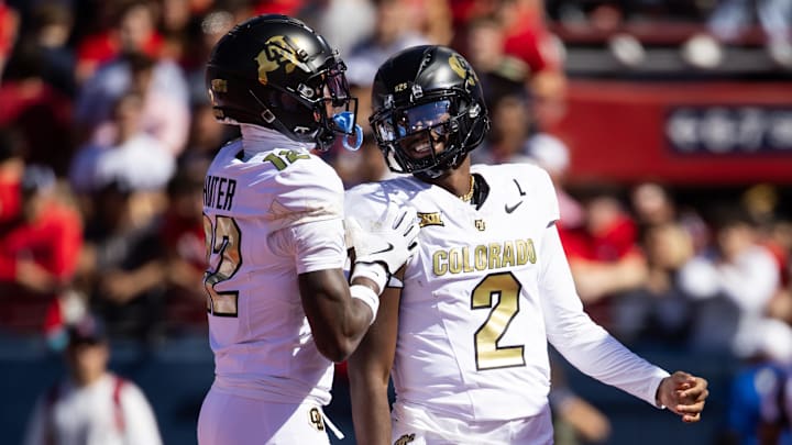 Oct 19, 2024; Tucson, Arizona, USA; Colorado Buffalos quarterback Shedeur Sanders (2) with wide receiver Travis Hunter (12) against the Arizona Wildcats at Arizona Stadium. Mandatory Credit: Mark J. Rebilas-Imagn Images
