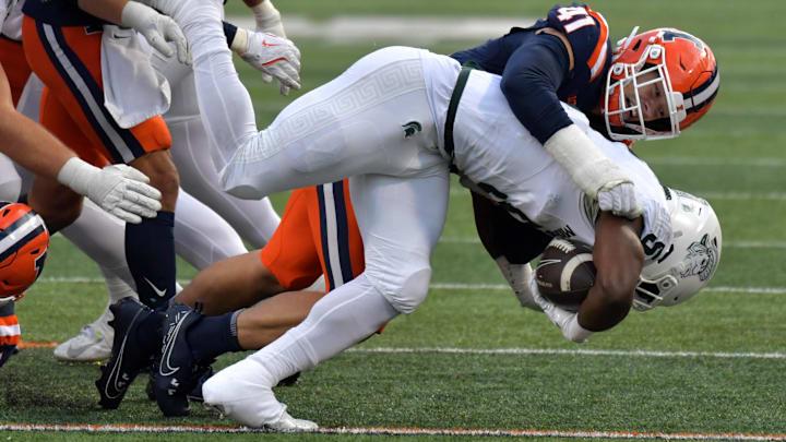 Nov 16, 2024; Champaign, Illinois, USA; Illinois Fighting Illini linebacker James Kreutz (41) tackles Michigan State Spartans running back Nate Carter (5) during the second half at Memorial Stadium. Mandatory Credit: Ron Johnson-Imagn Images