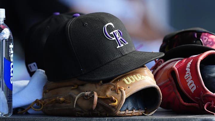 Jul 6, 2025; Denver, Colorado, USA; General view of a players cap and glove of the Colorado Rockies during the ninth inning against the Chicago White Sox at Coors Field. Mandatory Credit: Ron Chenoy-Imagn Images