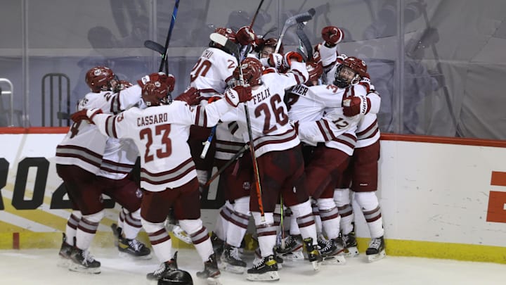 Apr 8, 2021; Pittsburgh, PA, USA; UMass Minutemen celebrate a goal by forward Garrett Wait (12) during overtime in the semifinals of the 2021 Frozen Four NCAA hockey tournament against the Minnesota Duluth Bulldogs at PPG Paints Arena. Mandatory Credit: Charles LeClaire-Imagn Images