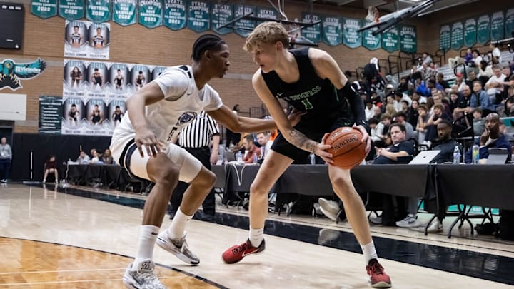 Jan 3, 2025; Gilbert, AZ, USA; Arizona Compass Prep forward Miikka Muurinen (1) against CIA Bella Vista (AZ) guard Austin Goode (5) during the Hoophall West High School Invitational at Highland High School. Mandatory Credit: Mark J. Rebilas-Imagn Images