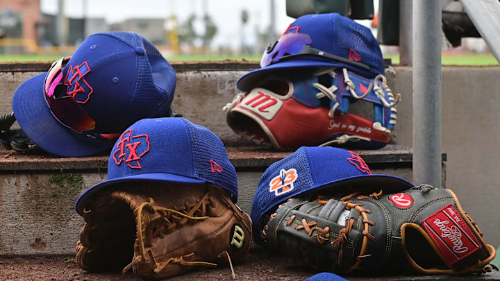 Mar 22, 2023; Scottsdale, Arizona, USA; A detail view of Texas Rangers hats and gloves during a Spring Training game against the San Francisco Giants at Scottsdale Stadium. Mar 22, 2023; Scottsdale, Arizona, USA; A detail view of Texas Rangers hats and gloves during a Spring Training game against the San Francisco Giants at Scottsdale Stadium.