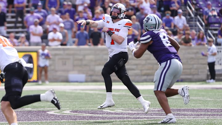 Sep 28, 2024; Manhattan, Kansas, USA; Oklahoma State Cowboys quarterback Alan Bowman (7) passes the ball against Kansas State Wildcats defensive end Chiddi Obiazor (8) during the fourth quarter at Bill Snyder Family Football Stadium. Mandatory Credit: Scott Sewell-Imagn Images Sep 28, 2024; Manhattan, Kansas, USA; Oklahoma State Cowboys quarterback Alan Bowman (7) passes the ball against Kansas State Wildcats defensive end Chiddi Obiazor (8) during the fourth quarter at Bill Snyder Family Football Stadium. Mandatory Credit: Scott Sewell-Imagn Images