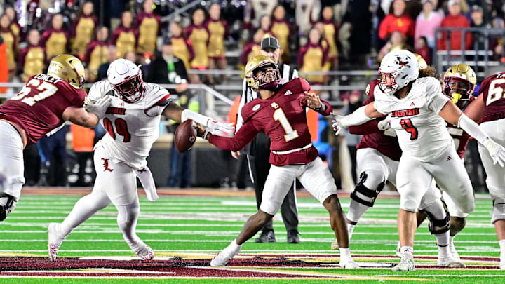 Oct 25, 2024; Chestnut Hill, Massachusetts, USA; Louisville Cardinals defensive lineman Dezmond Tell (99) blocks the arm of Boston College Eagles quarterback Thomas Castellanos (1) during the second half at Alumni Stadium. Mandatory Credit: Eric Canha-Imagn Images