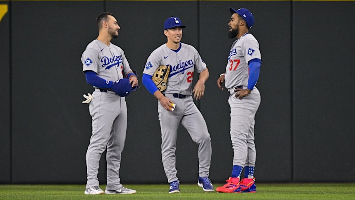 Apr 20, 2025; Arlington, Texas, USA; Los Angeles Dodgers left fielder Michael Conforto (23) and center fielder Tommy Edman (25) and right fielder Teoscar Hernandez (37) during the game between the Texas Rangers and the Los Angeles Dodgers at Globe Life Field. Mandatory Credit: Jerome Miron-Imagn Images