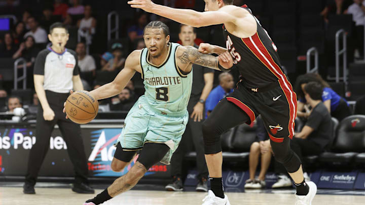 Mar 23, 2025; Miami, Florida, USA; Charlotte Hornets guard Nick Smith Jr. (8) is defended by Miami Heat forward Duncan Robinson (55) during the first half at Kaseya Center. Mandatory Credit: Rhona Wise-Imagn Images