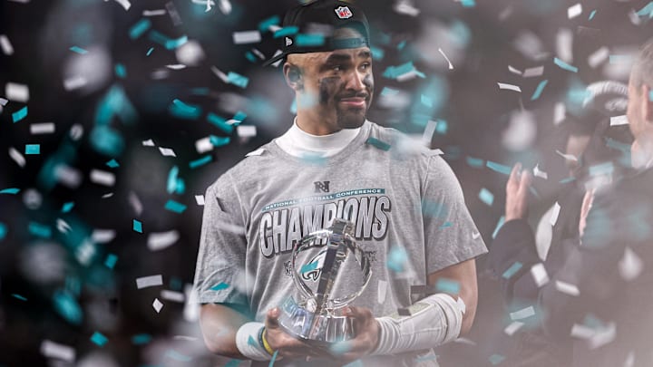 Philadelphia Eagles quarterback Jalen Hurts (1) holds the NFC Championship trophy after a victory in the NFC Championship game against the Washington Commanders.