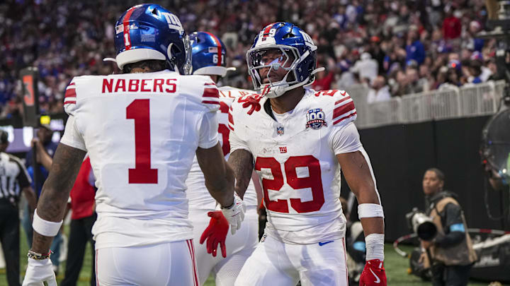 New York Giants running back Tyrone Tracy Jr. (29) reacts with wide receiver Malik Nabers (1) after catching a touchdown pass against the Atlanta Falcons during the first half at Mercedes-Benz Stadium. 